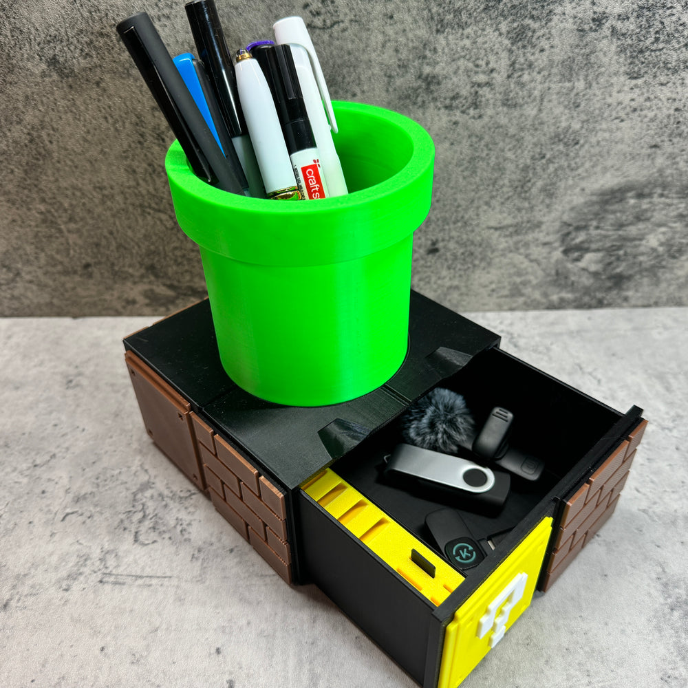 a green cup filled with pens and pencils