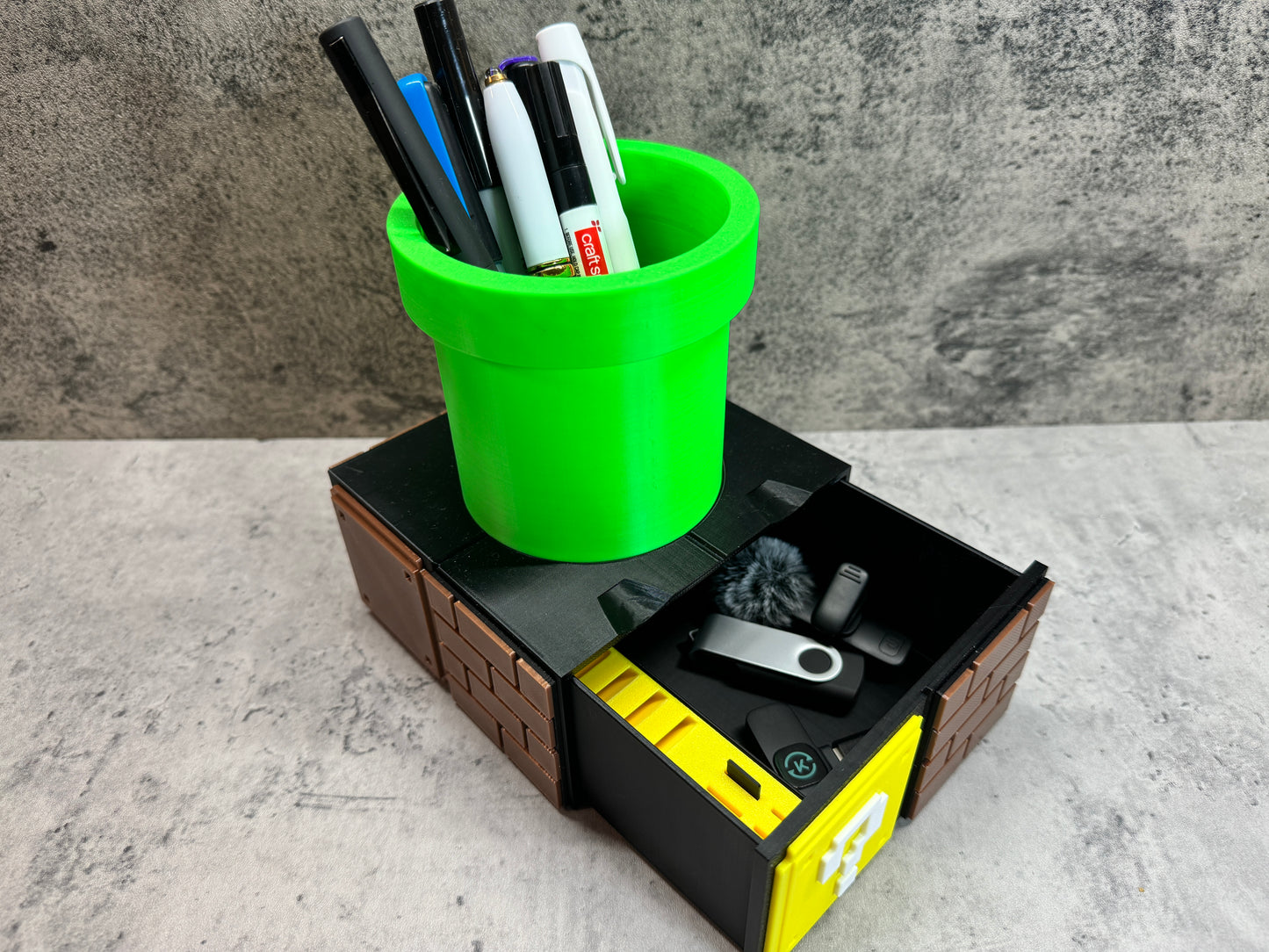 a green cup filled with pens and pencils