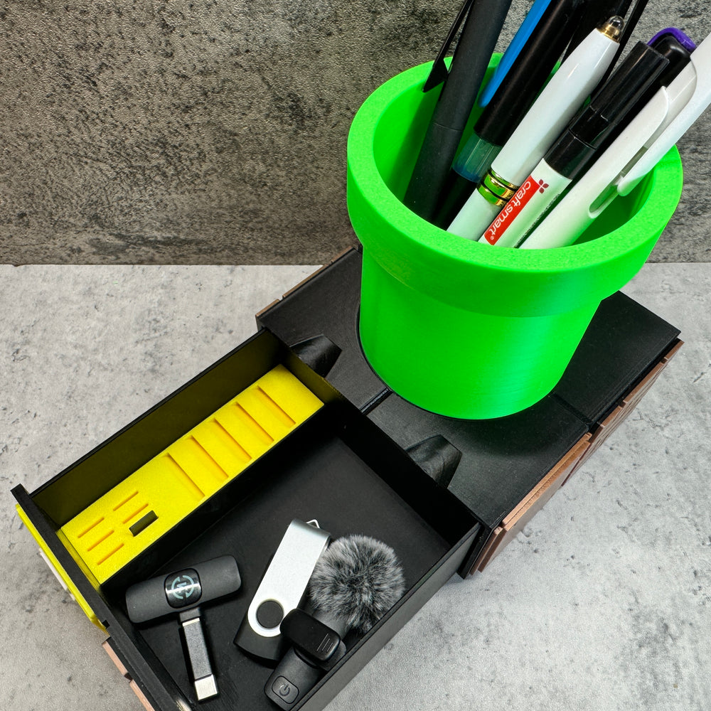 
                  
                    a green cup filled with pens and other office supplies
                  
                