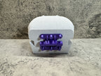 a close up of a purple object on a table