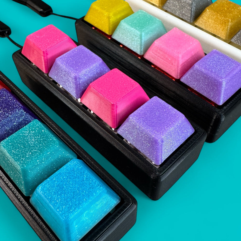 
                  
                    Colorful keycaps in black cases on a turquoise background
                  
                