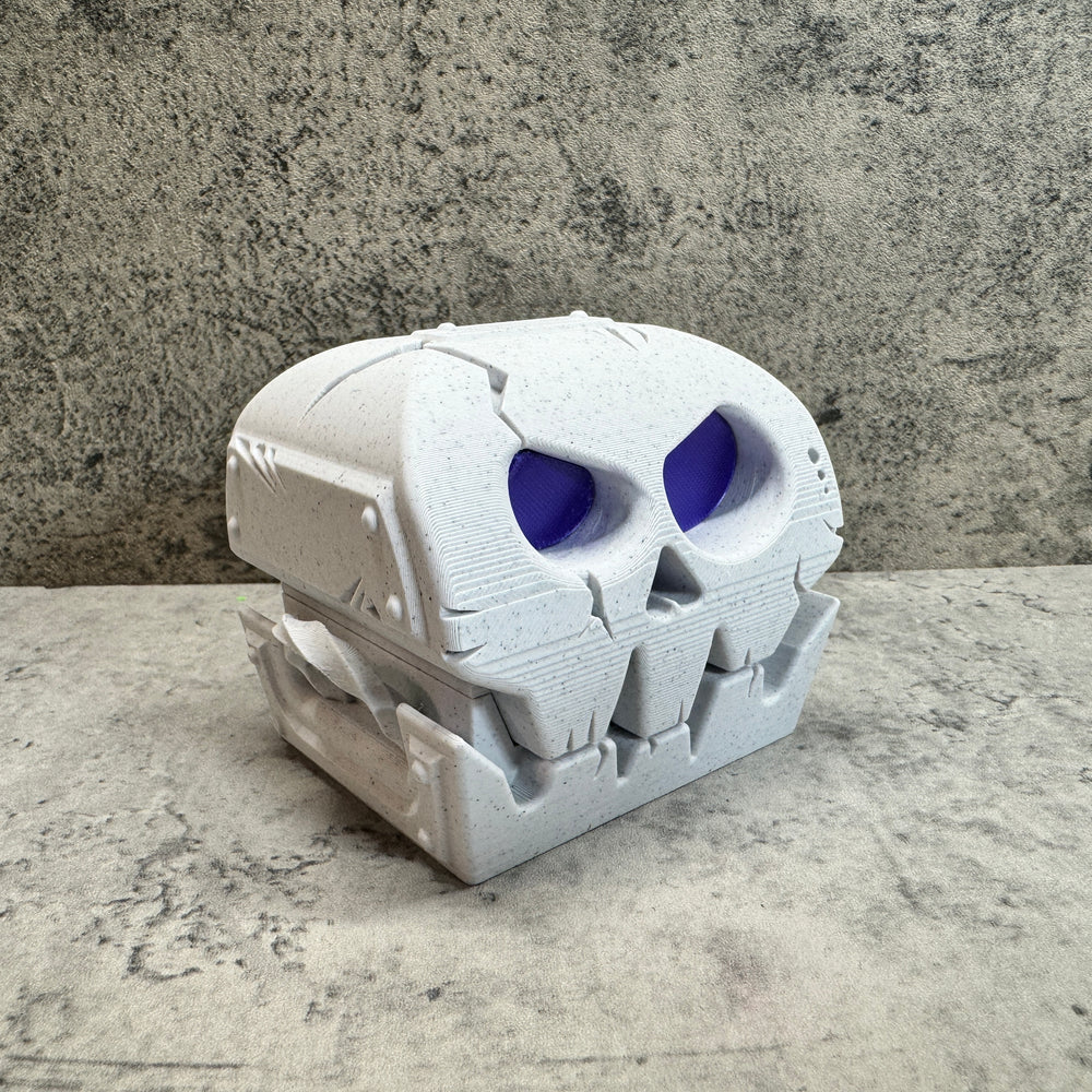 
                  
                    a white skull with blue eyes on a table
                  
                