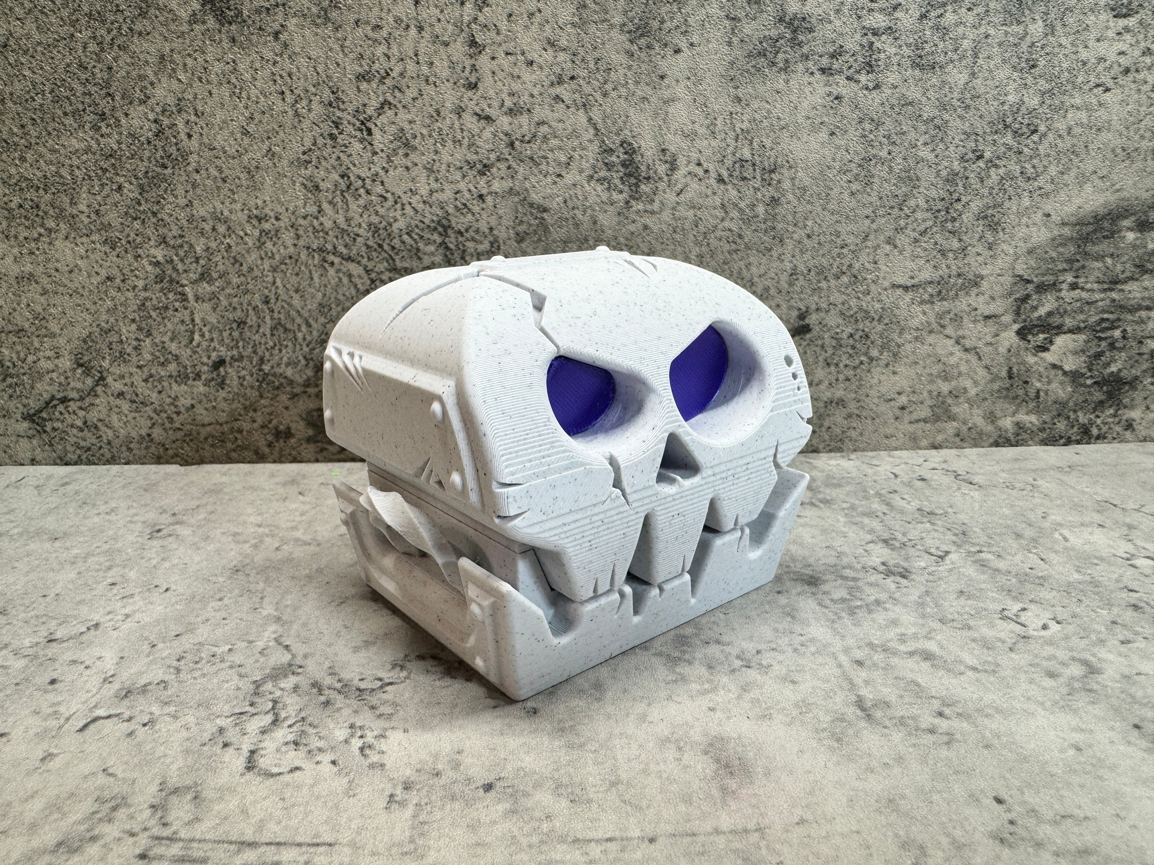 a white skull with blue eyes on a table