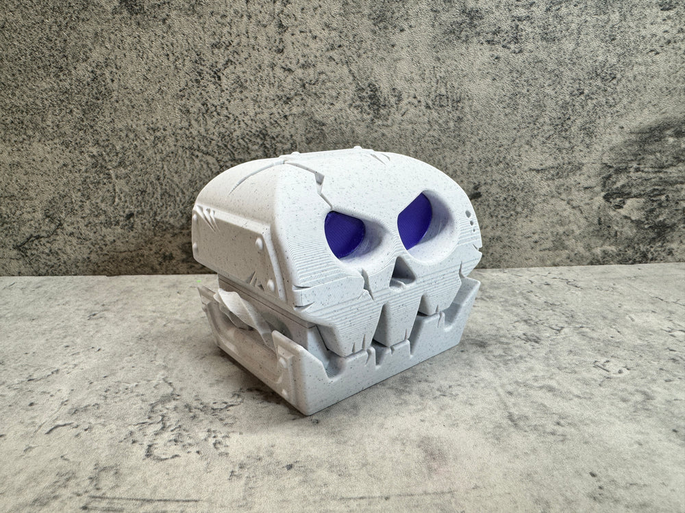 
                  
                    a white skull with blue eyes on a table
                  
                