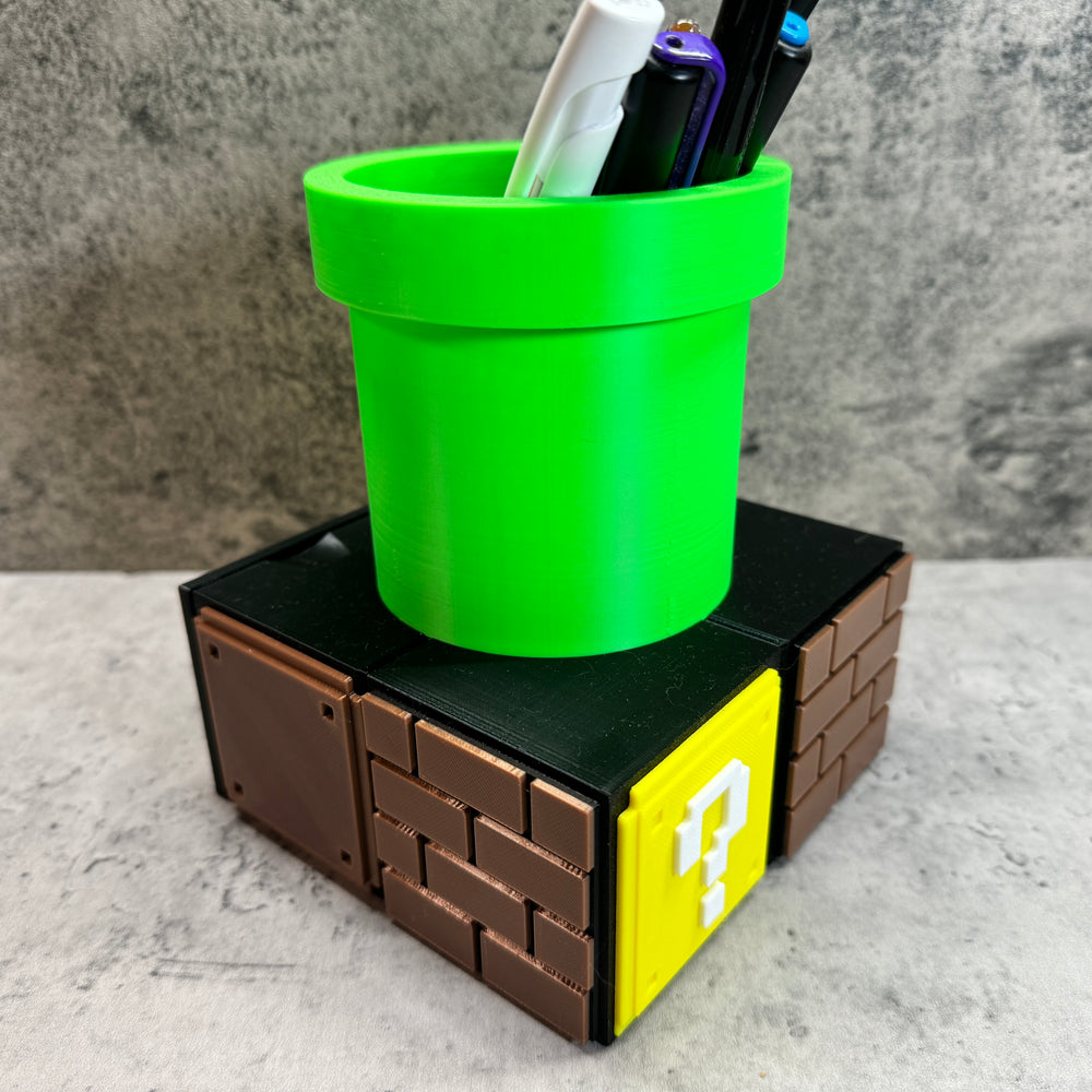 
                  
                    a green cup sitting on top of a lego block
                  
                