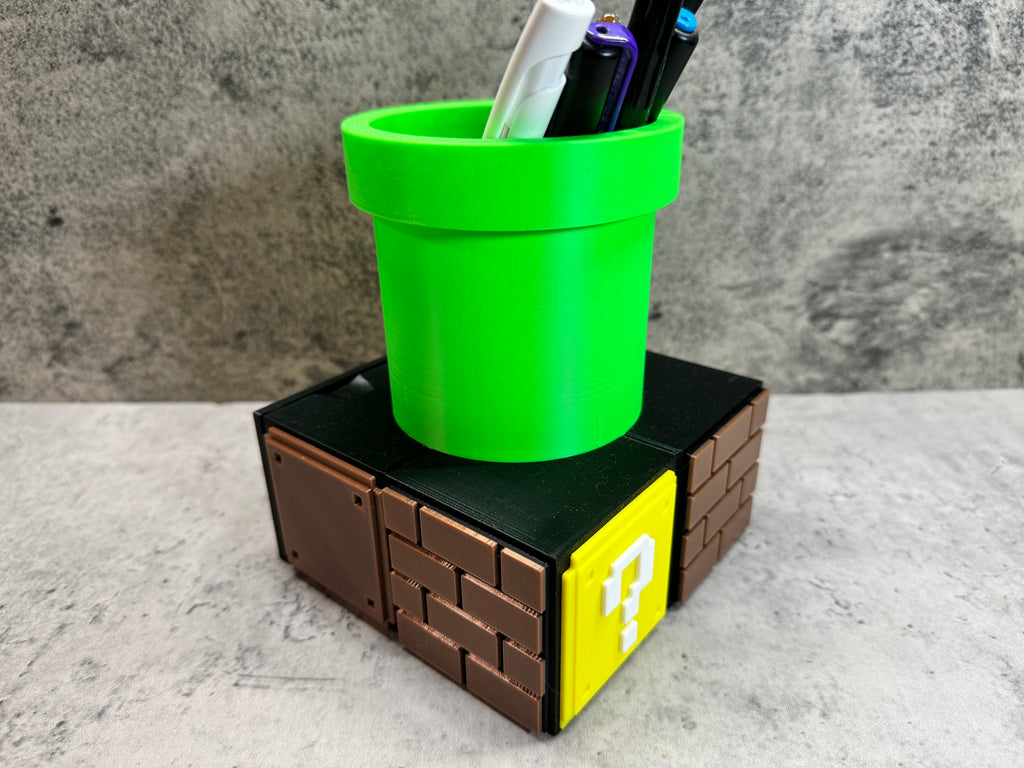 a green cup sitting on top of a lego block