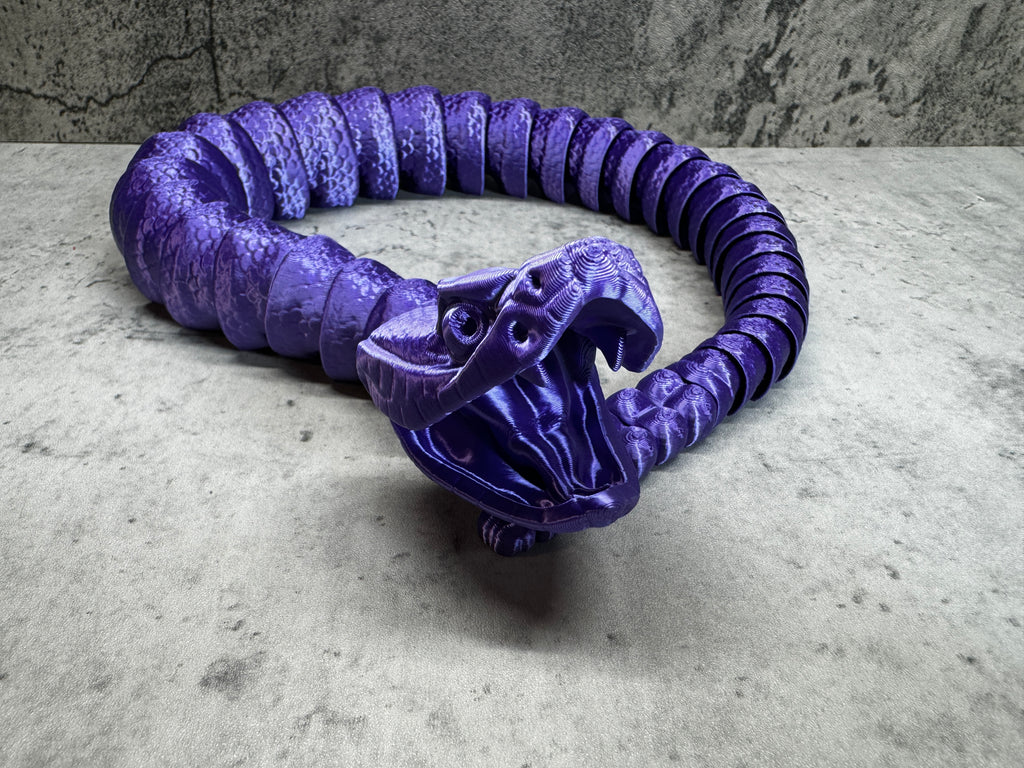 a purple snake sculpture sitting on top of a table