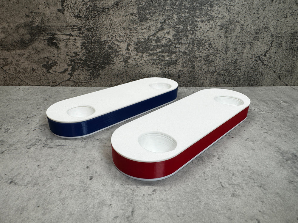 
                  
                    two white and red bowls sitting on top of a table
                  
                