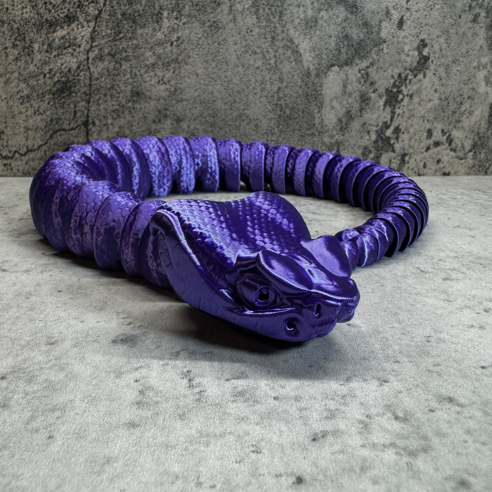 
                  
                    a purple coiled object sitting on top of a table
                  
                