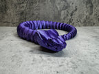 a purple coiled object sitting on top of a table