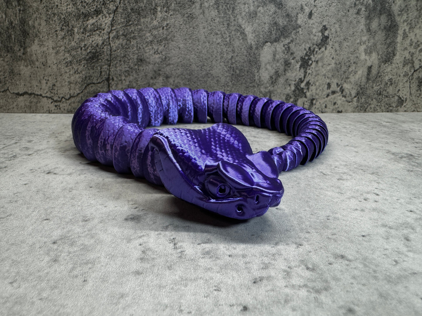 
                  
                    a purple coiled object sitting on top of a table
                  
                