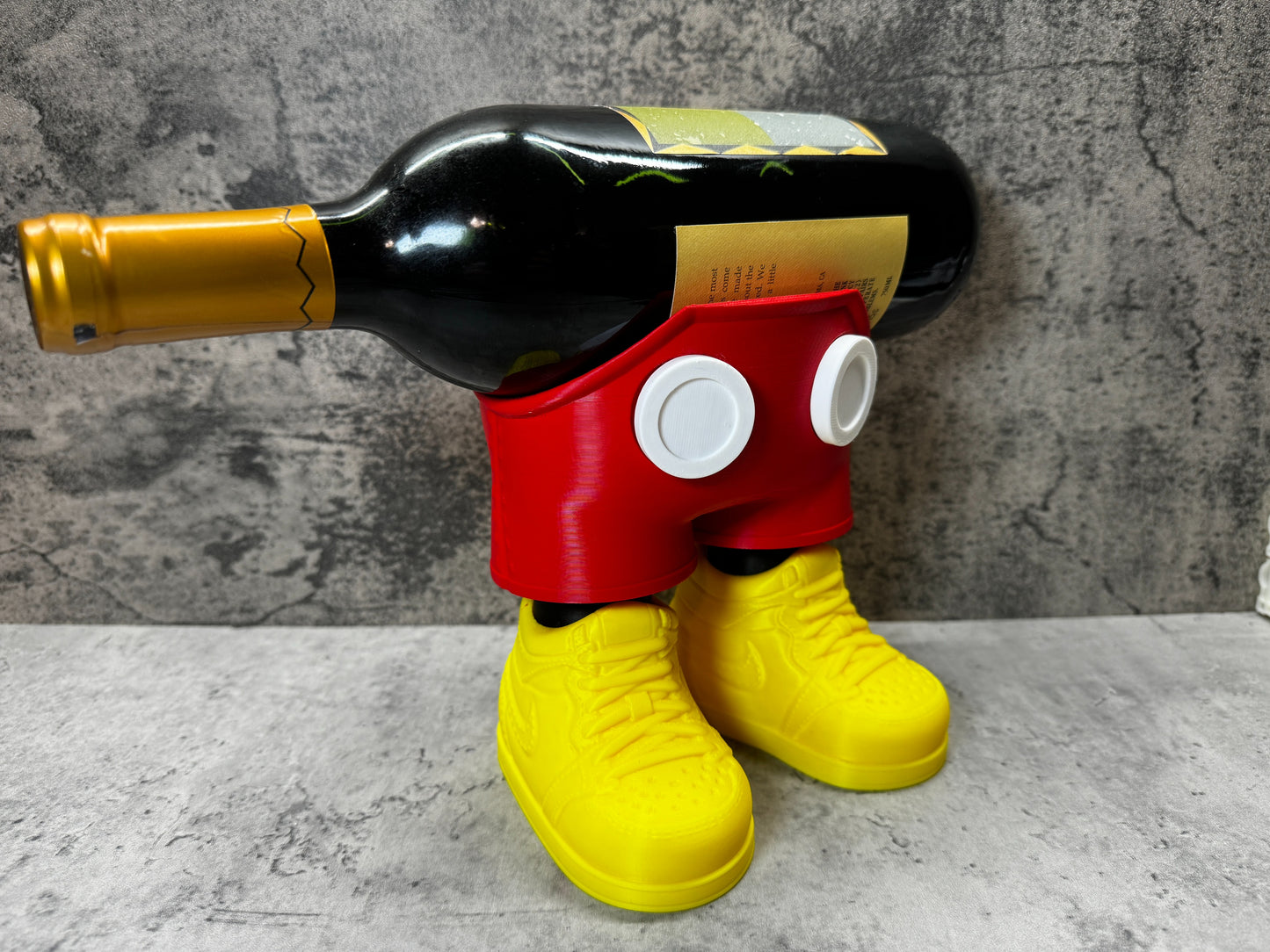 
                  
                    a mickey mouse bottle holder with a wine bottle in it
                  
                