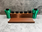 a set of three green cups sitting on top of a counter