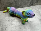 a toy lizard is sitting on the floor