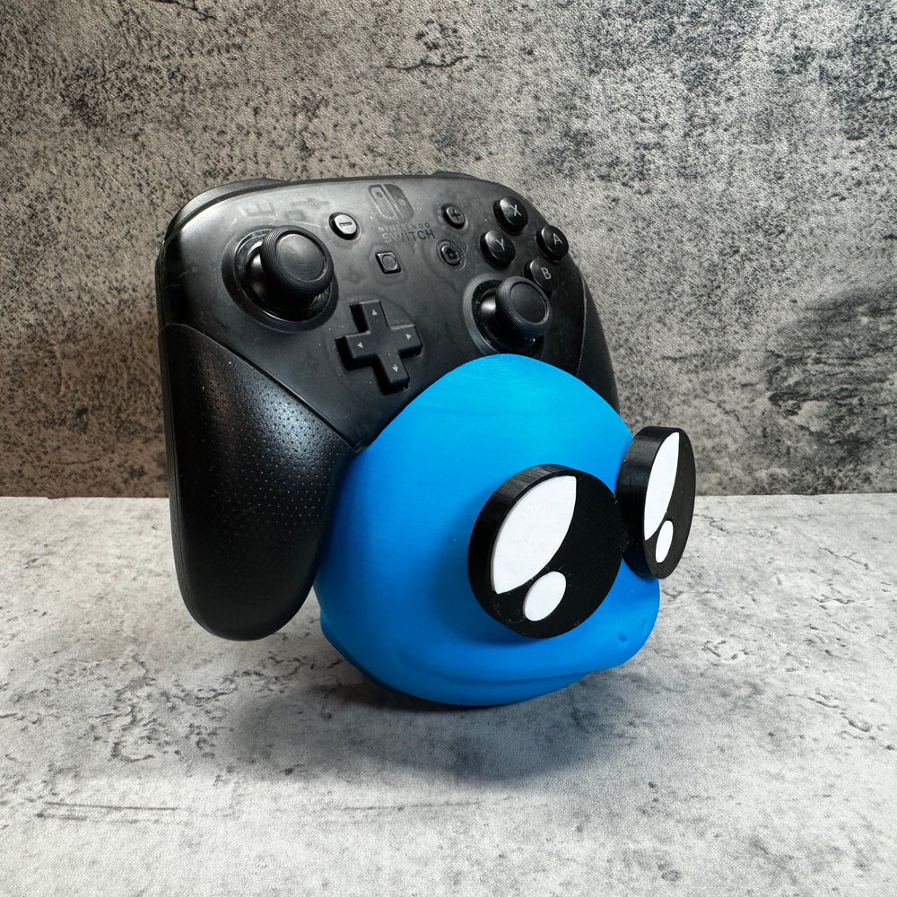 
                  
                    a close up of a controller with a face on it
                  
                