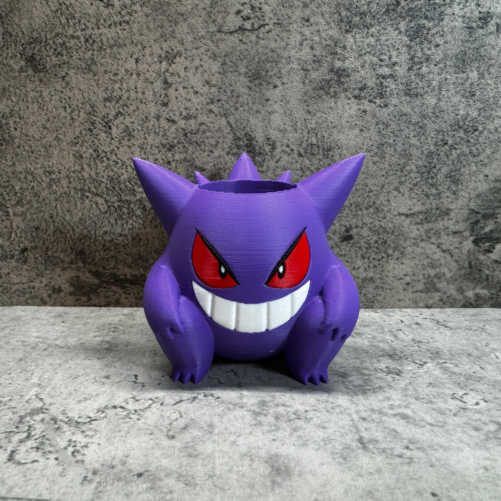 
                  
                    a purple toy sitting on top of a table
                  
                