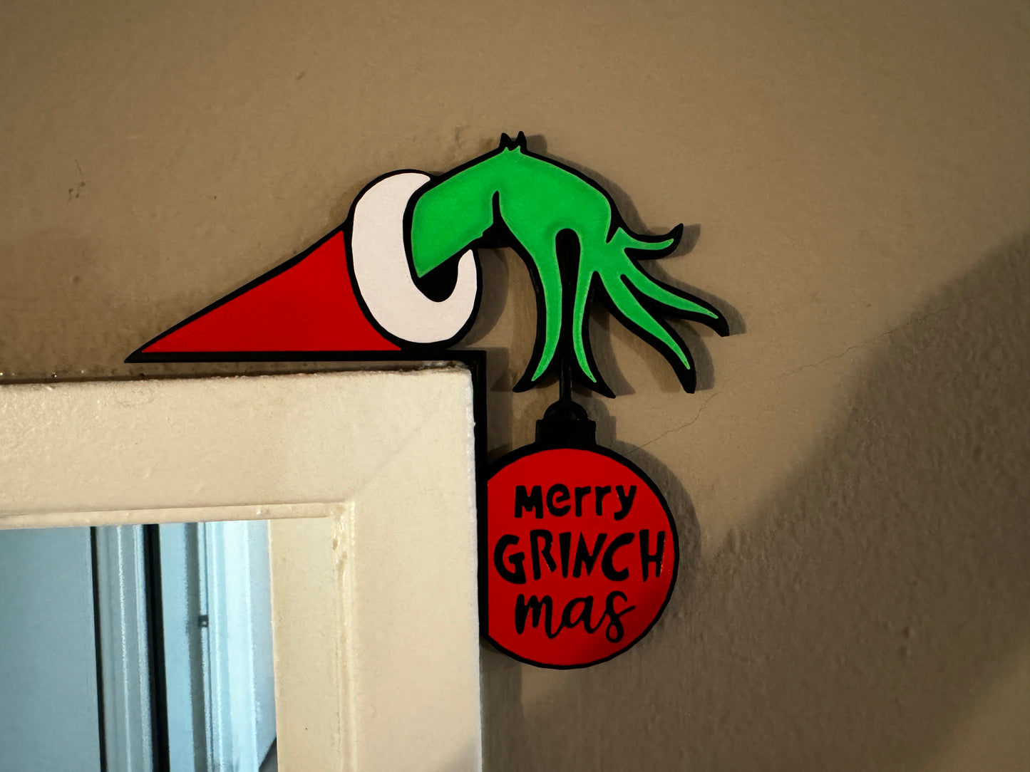 
                  
                    a sign that says merry grinch mash hanging on a wall
                  
                