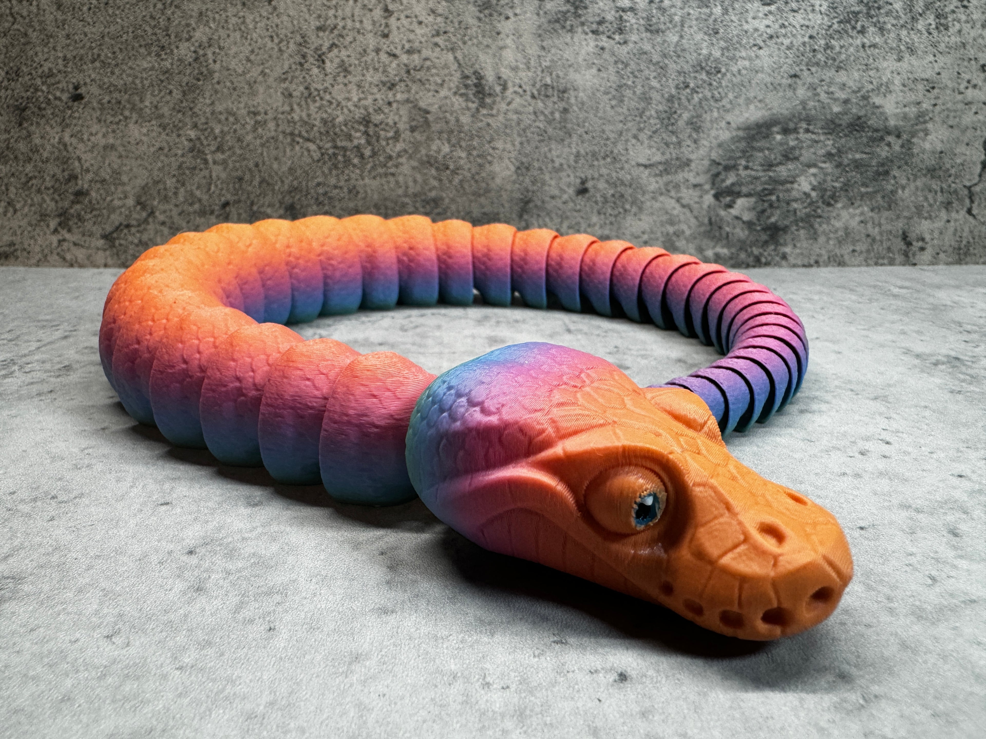 a toy snake is laying on the ground