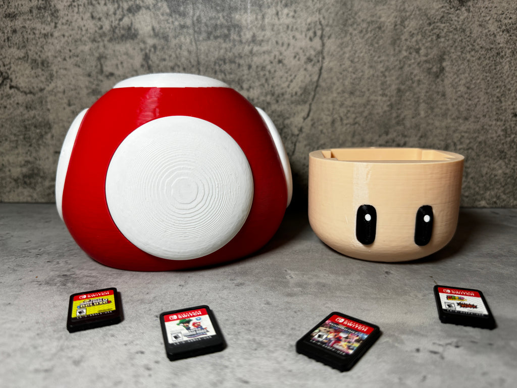 a red and white object next to a bowl of gameboy games