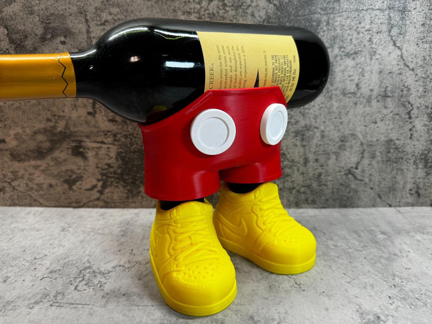 
                  
                    a wine bottle holder made to look like mickey mouse
                  
                