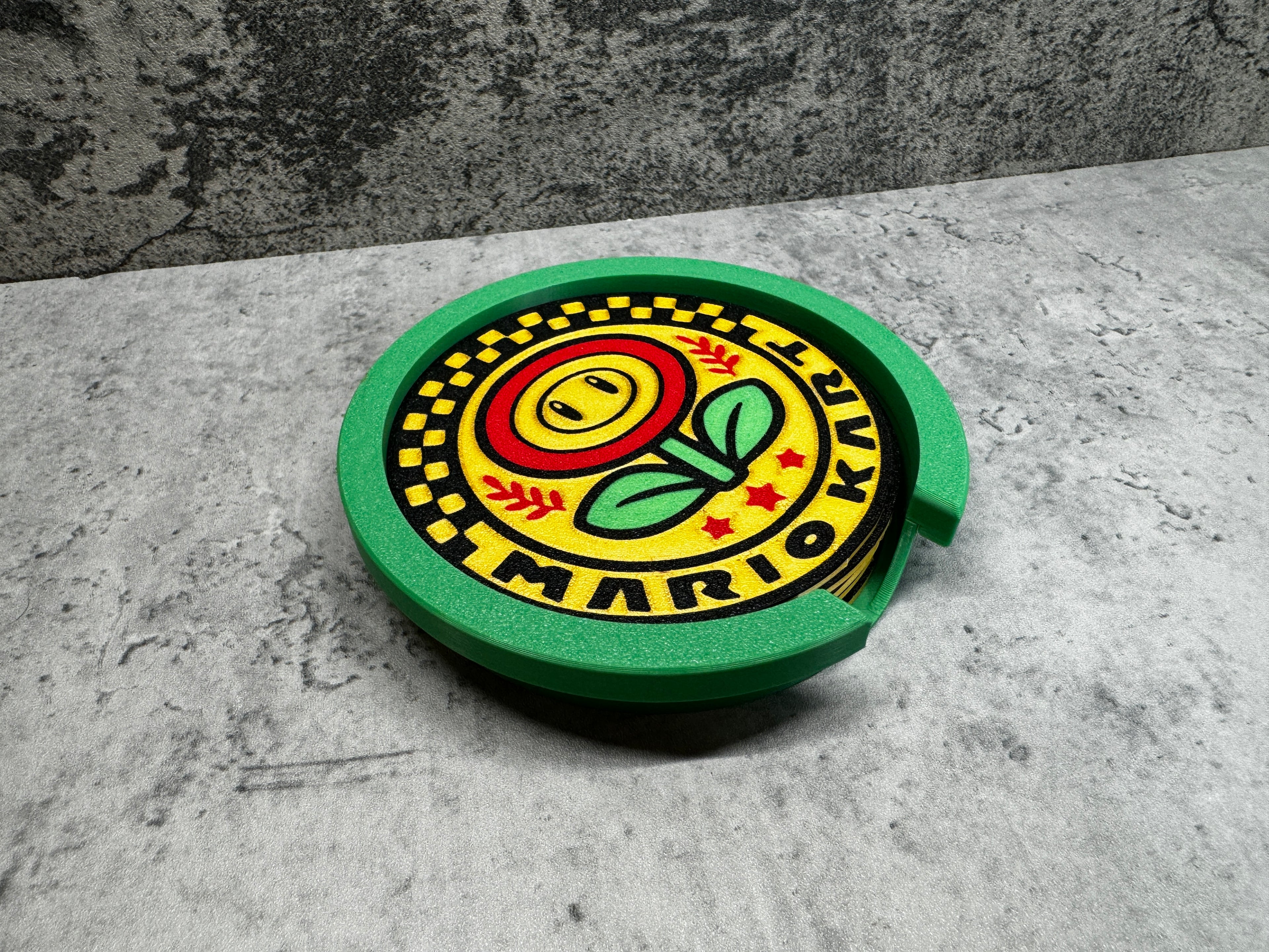 a green and yellow plate with a flower on it