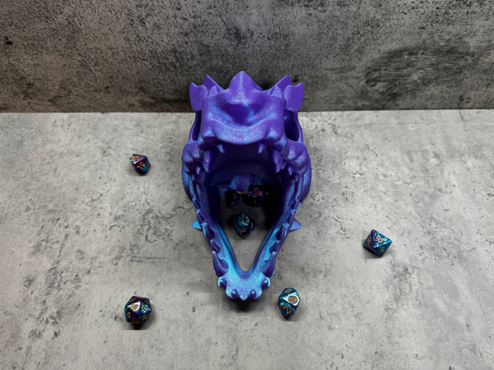 
                  
                    a purple and blue object sitting on top of a cement floor
                  
                
