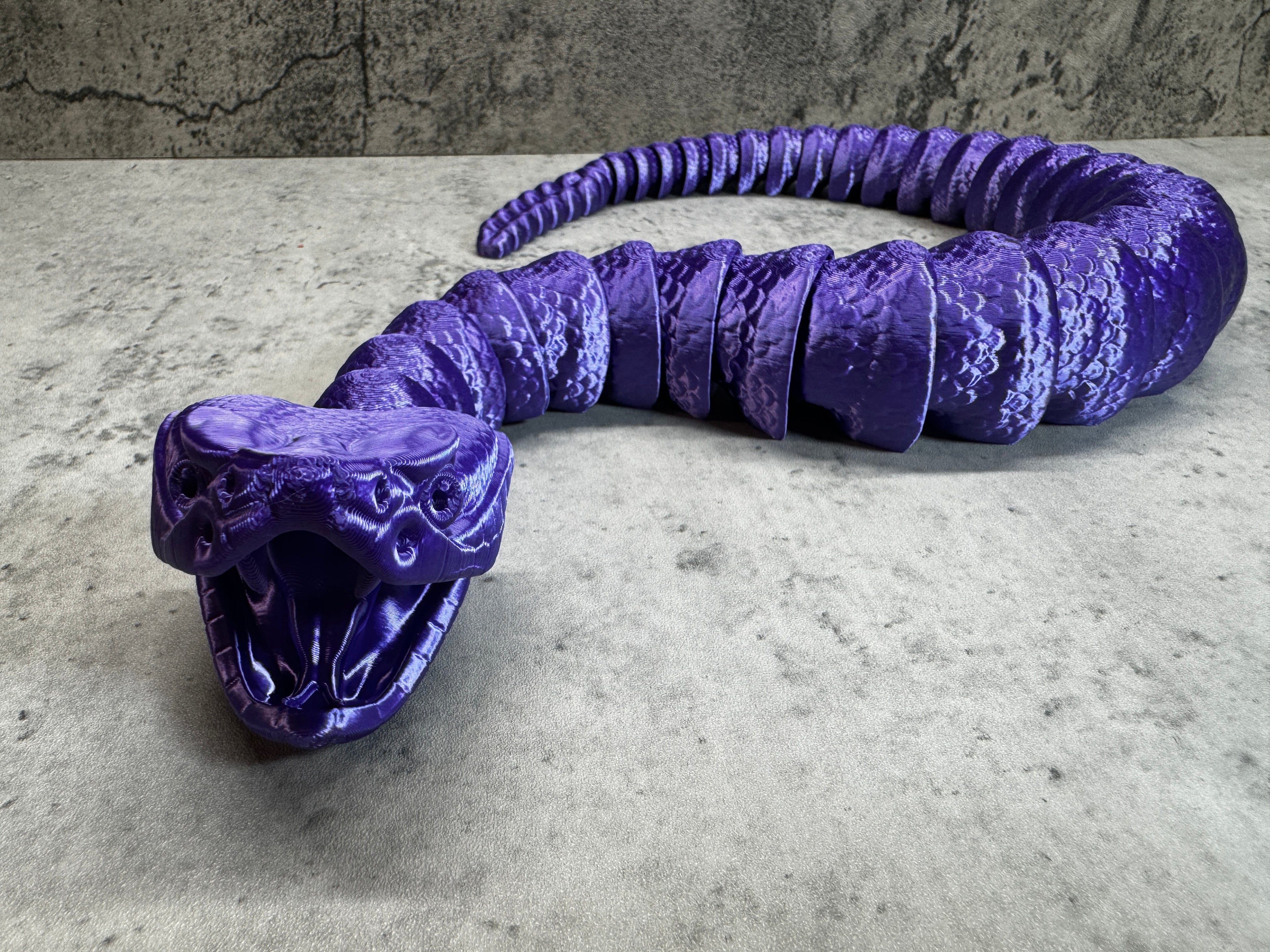 a purple snake sculpture sitting on top of a table