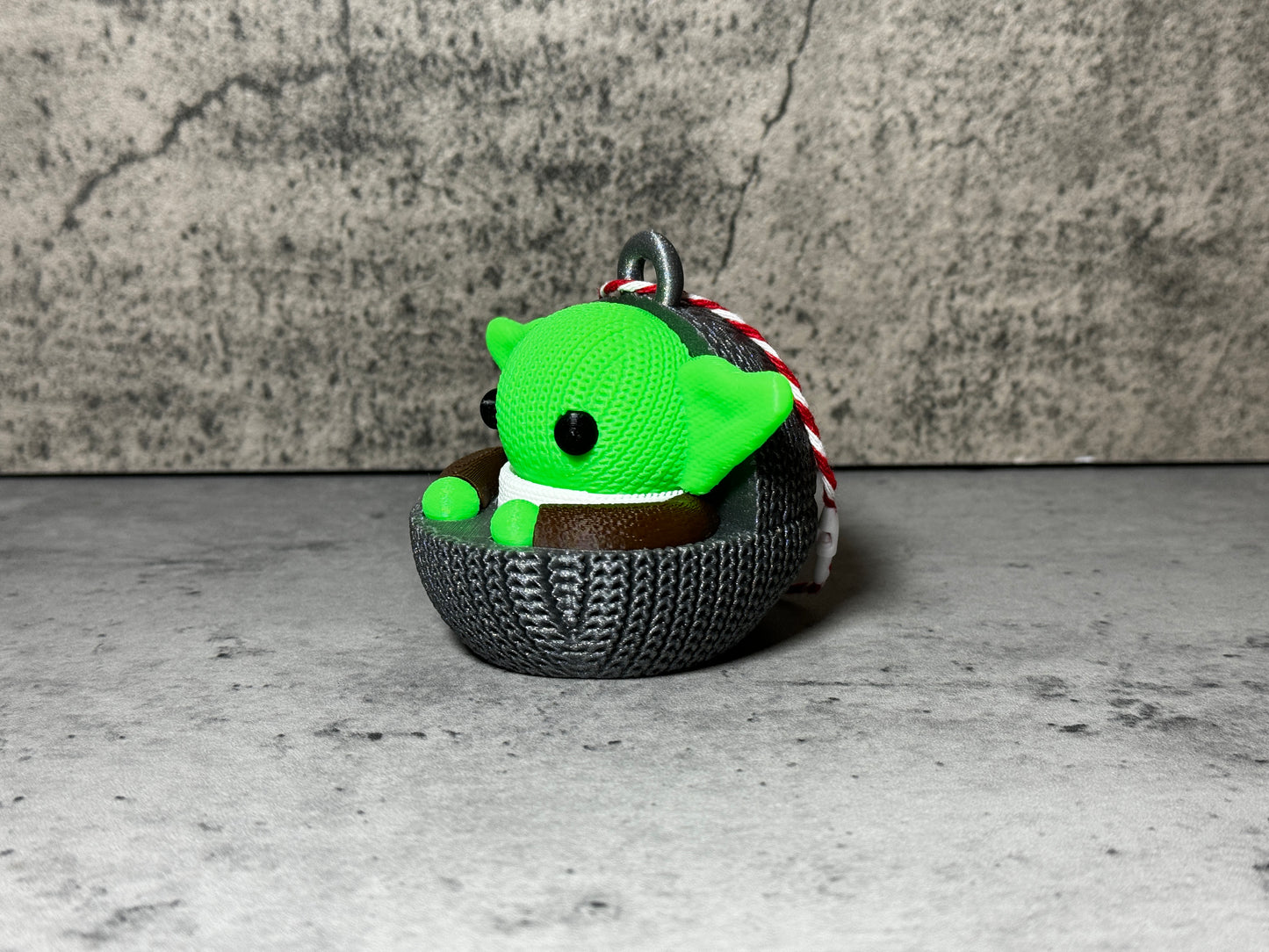 
                  
                    a green stuffed animal sitting in a basket
                  
                