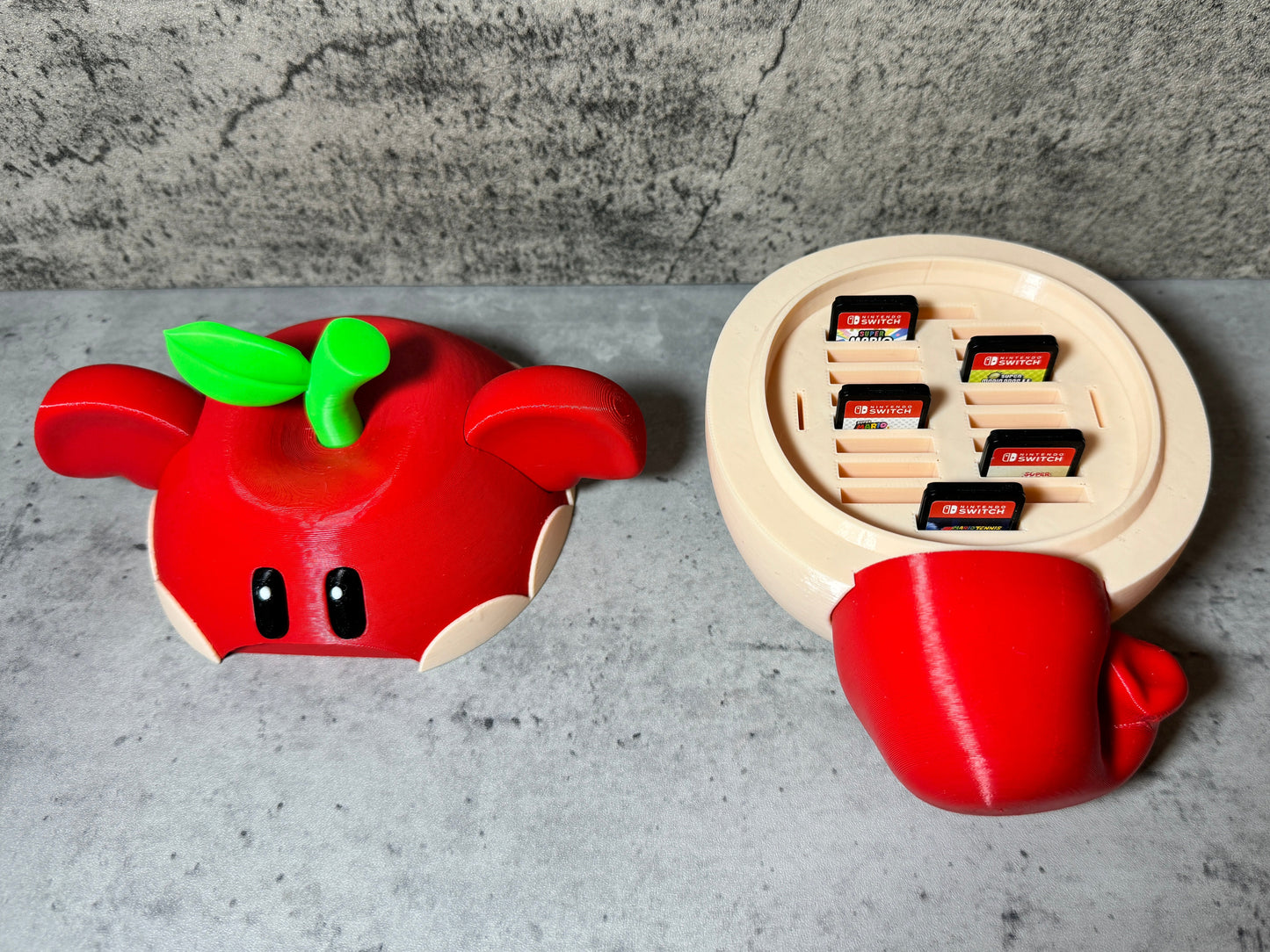 a nintendo wii game controller next to a red apple