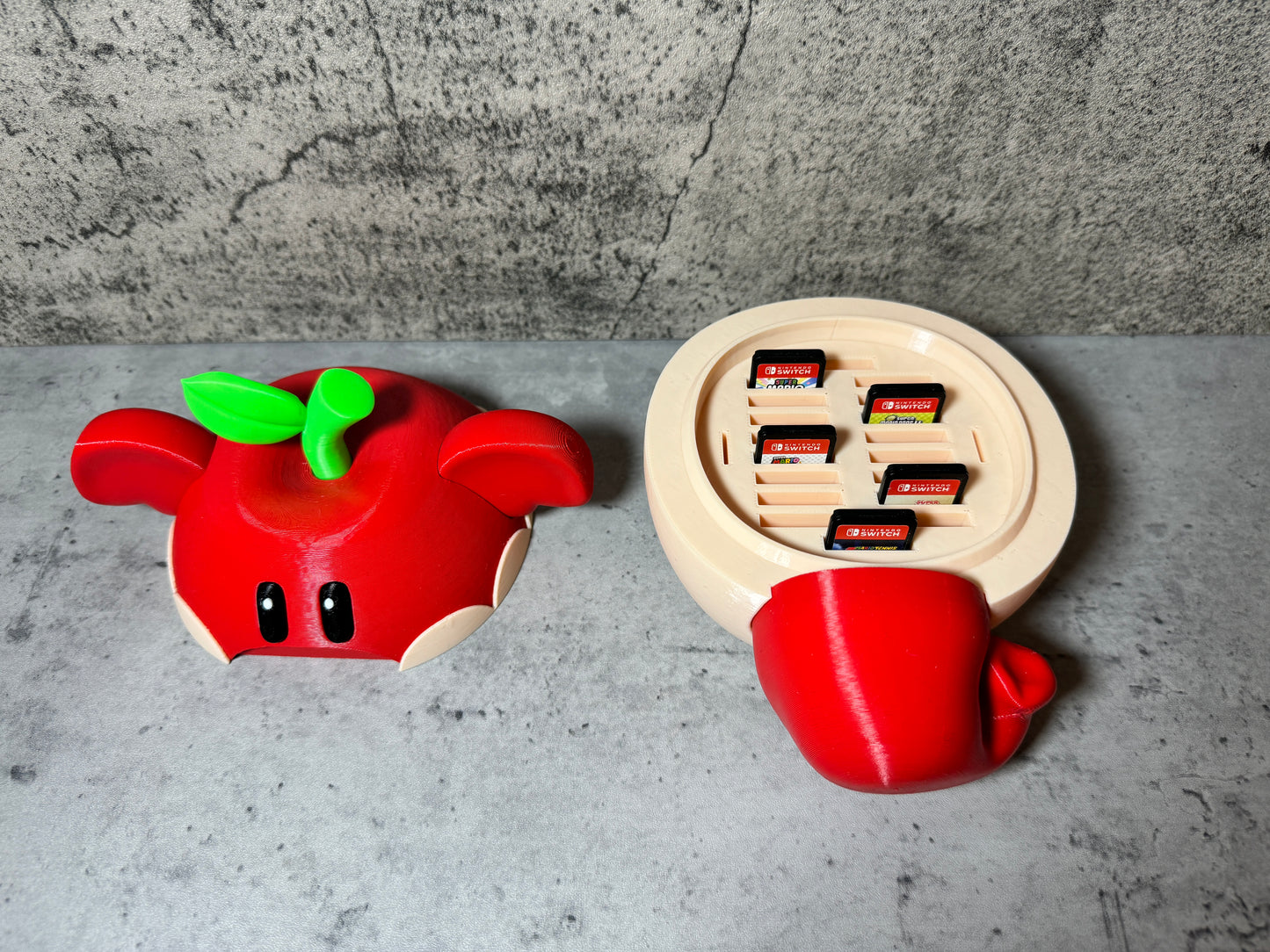 
                  
                    a nintendo wii game controller next to a red apple
                  
                