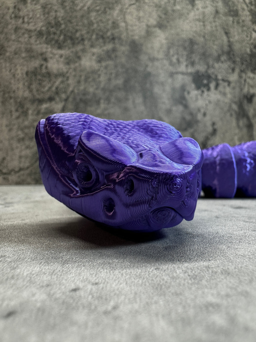 a purple shoe hanging on the side of a wall