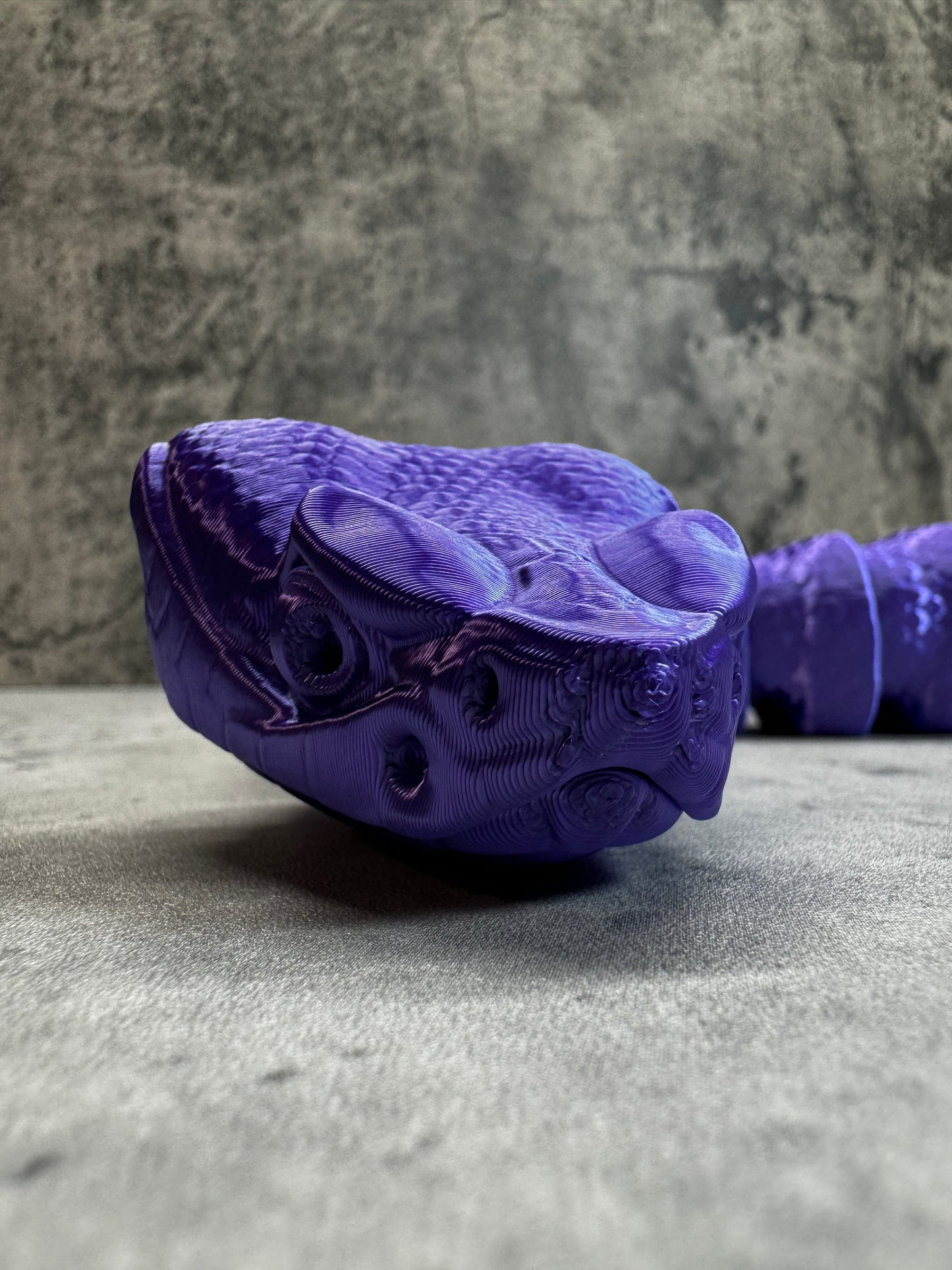 
                  
                    a purple shoe hanging on the side of a wall
                  
                