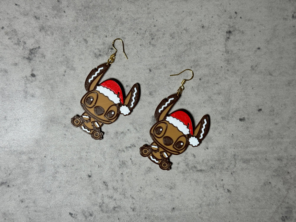 
                  
                    a pair of earrings with a dog wearing a santa hat
                  
                