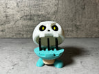 a toy with a toothbrush in it's mouth