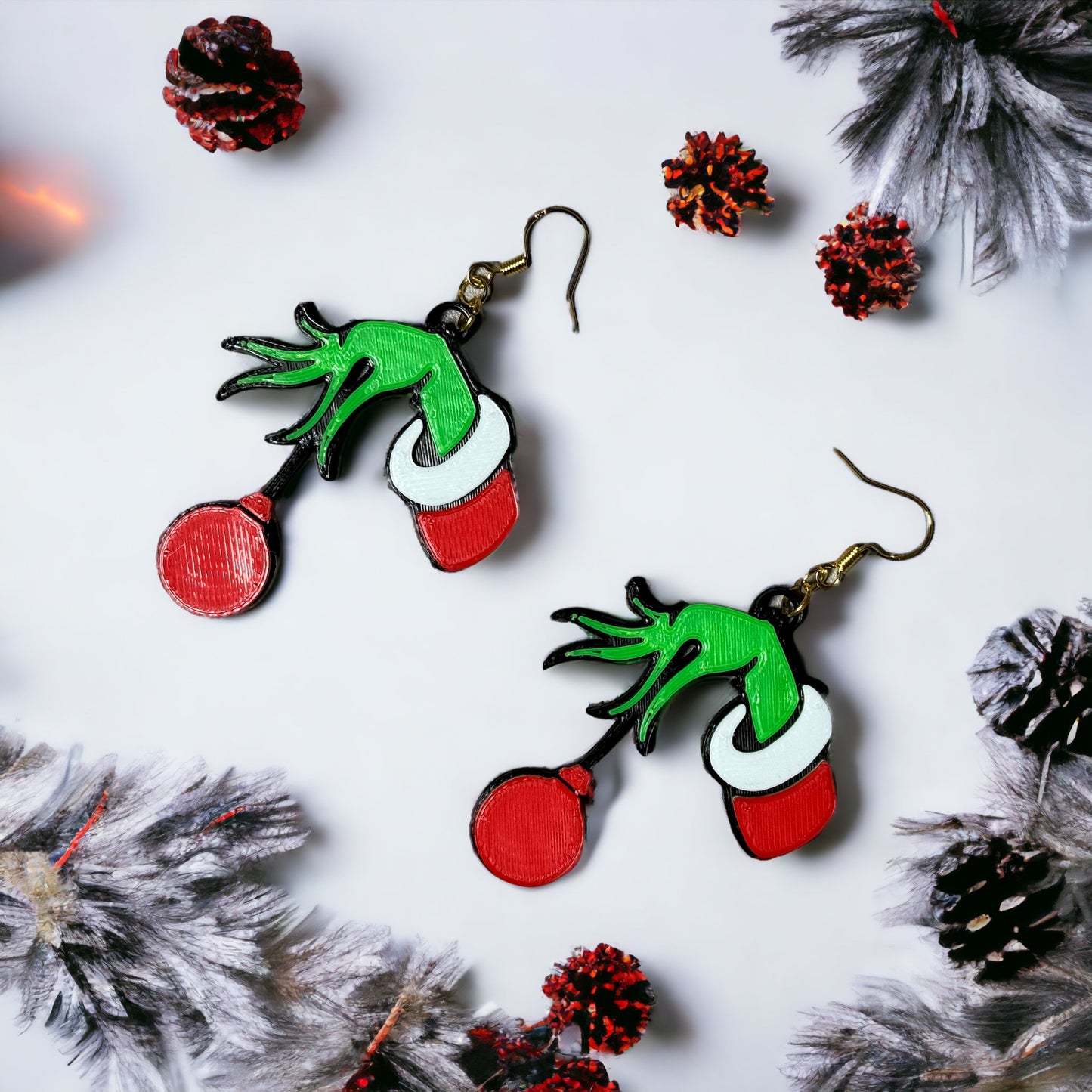 a pair of red and green christmas themed earrings