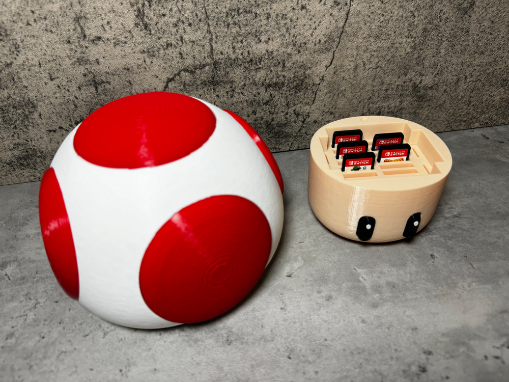 
                  
                    a red and white ball sitting next to a white and black object
                  
                