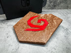 a wooden object with a red letter on it