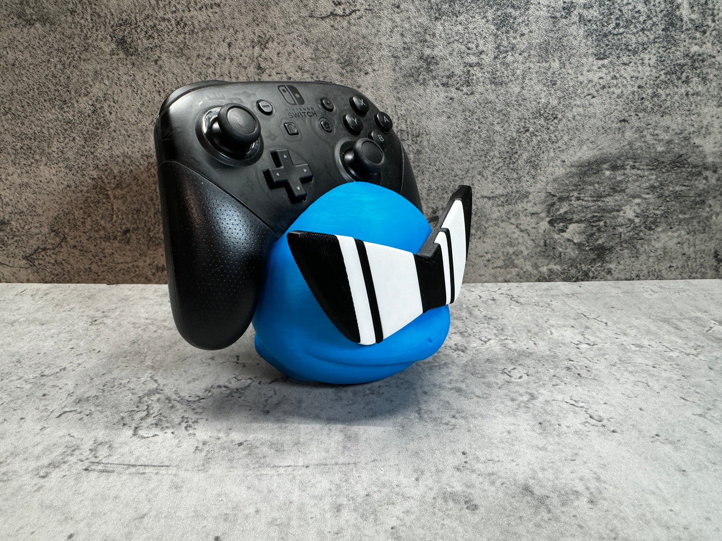 
                  
                    a close up of a controller and a ball
                  
                