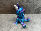 a blue and purple toy sitting on top of a table