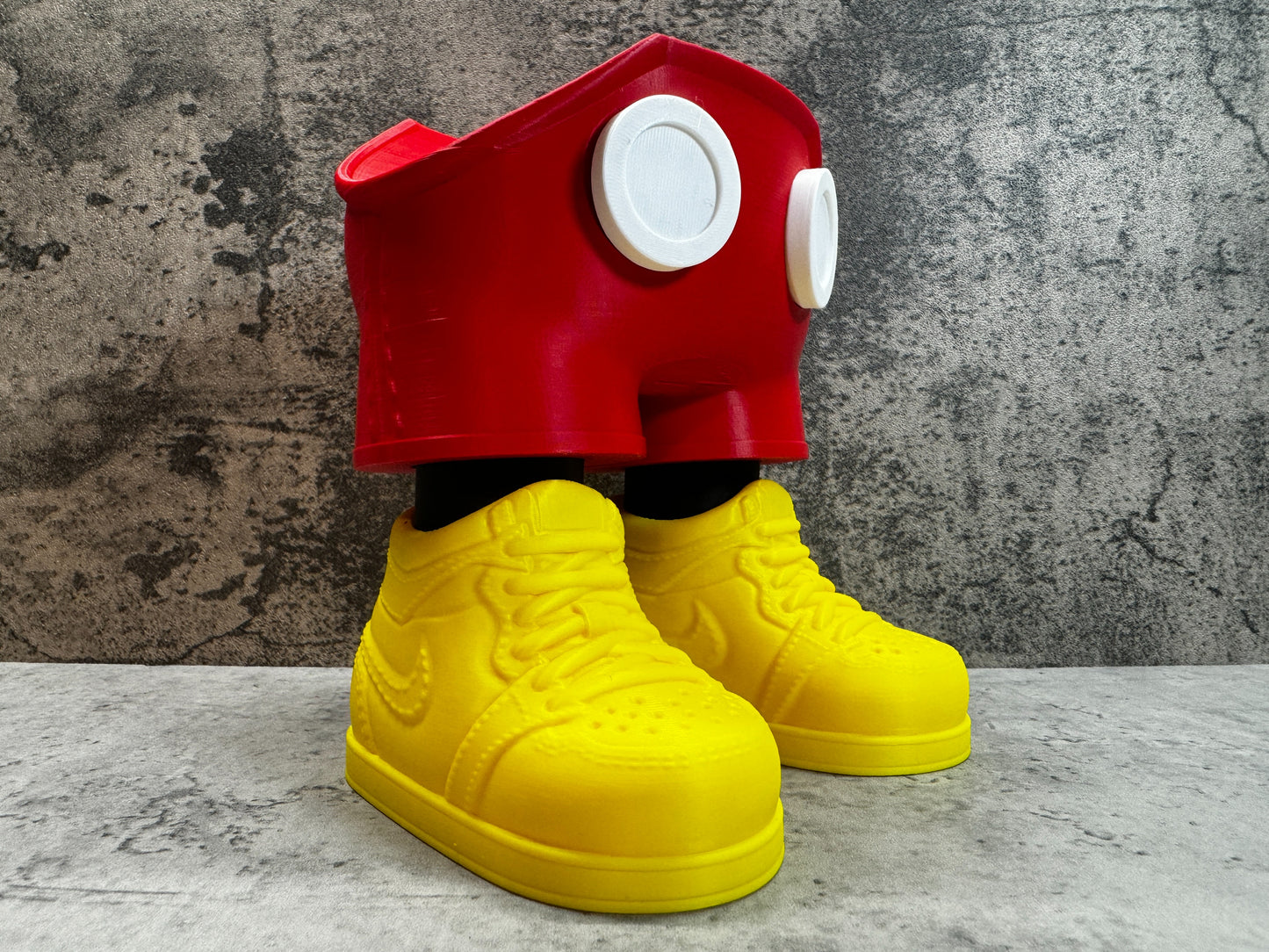 
                  
                    a pair of yellow shoes with a red shoe on top of them
                  
                