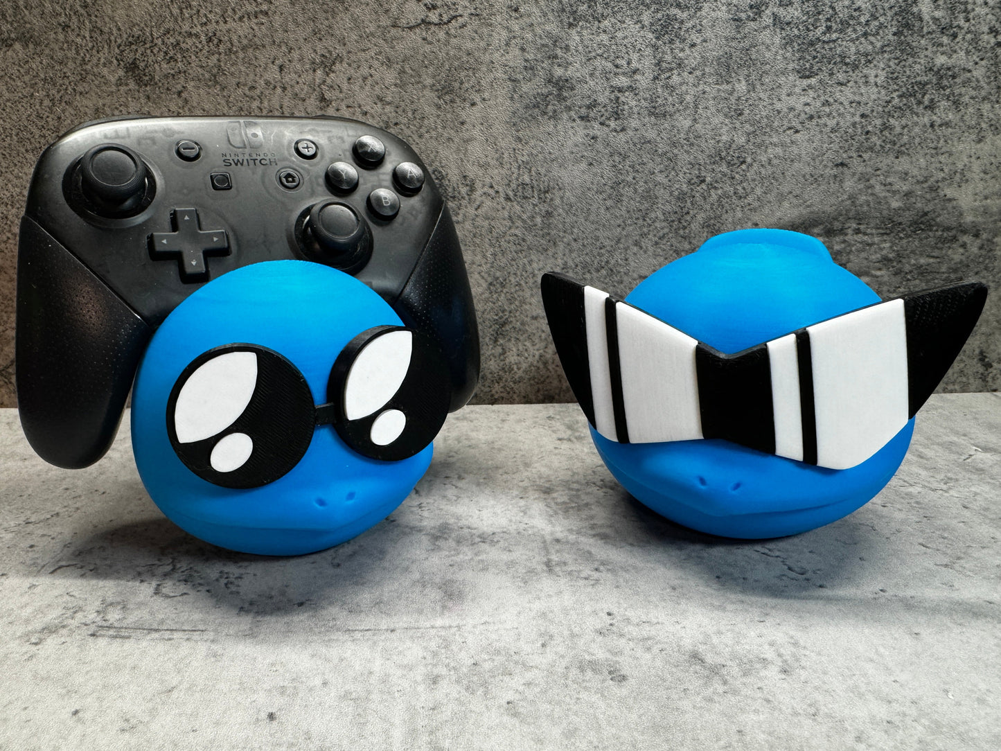 two video game controllers sitting next to each other