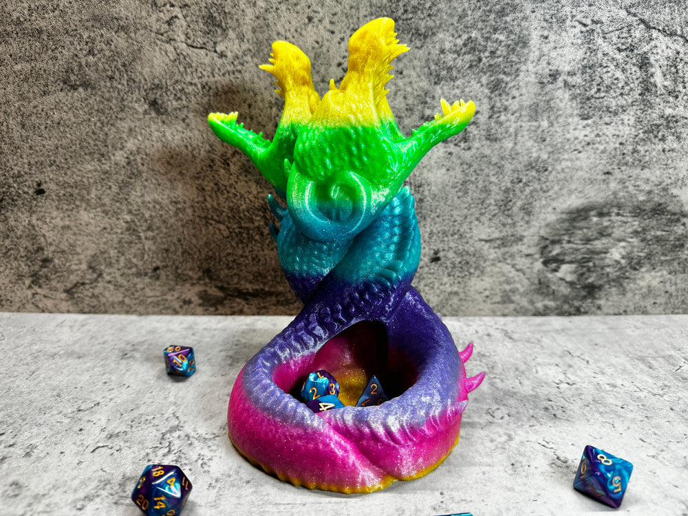
                  
                    a colorful dragon figurine sitting on top of a table
                  
                