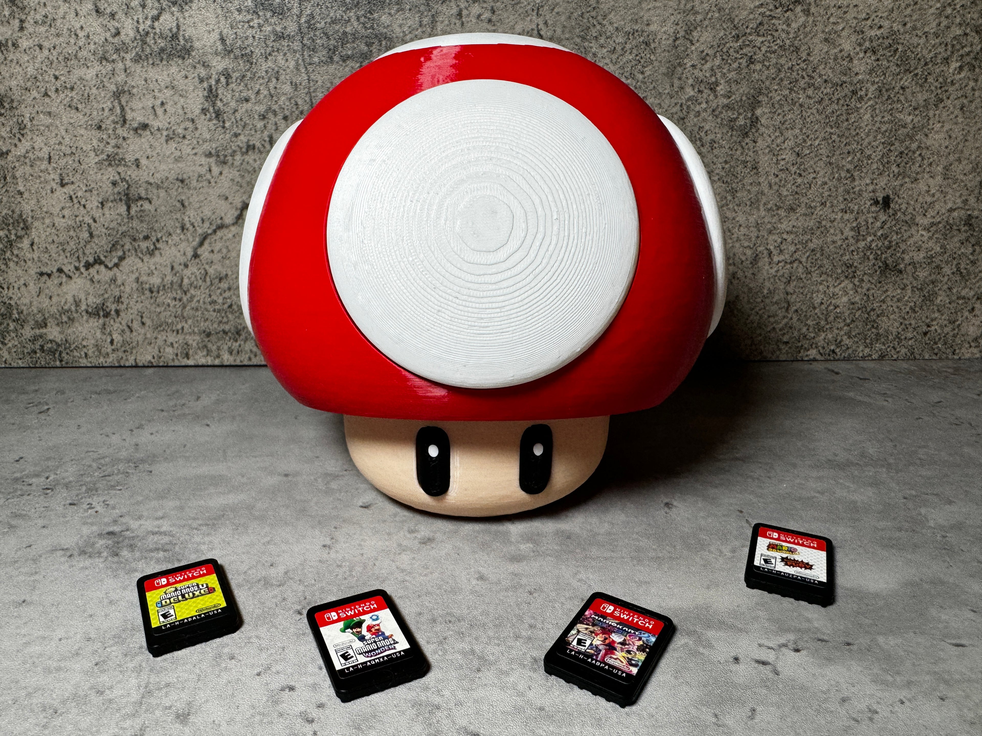 a red mushroom with four gameboy games on it