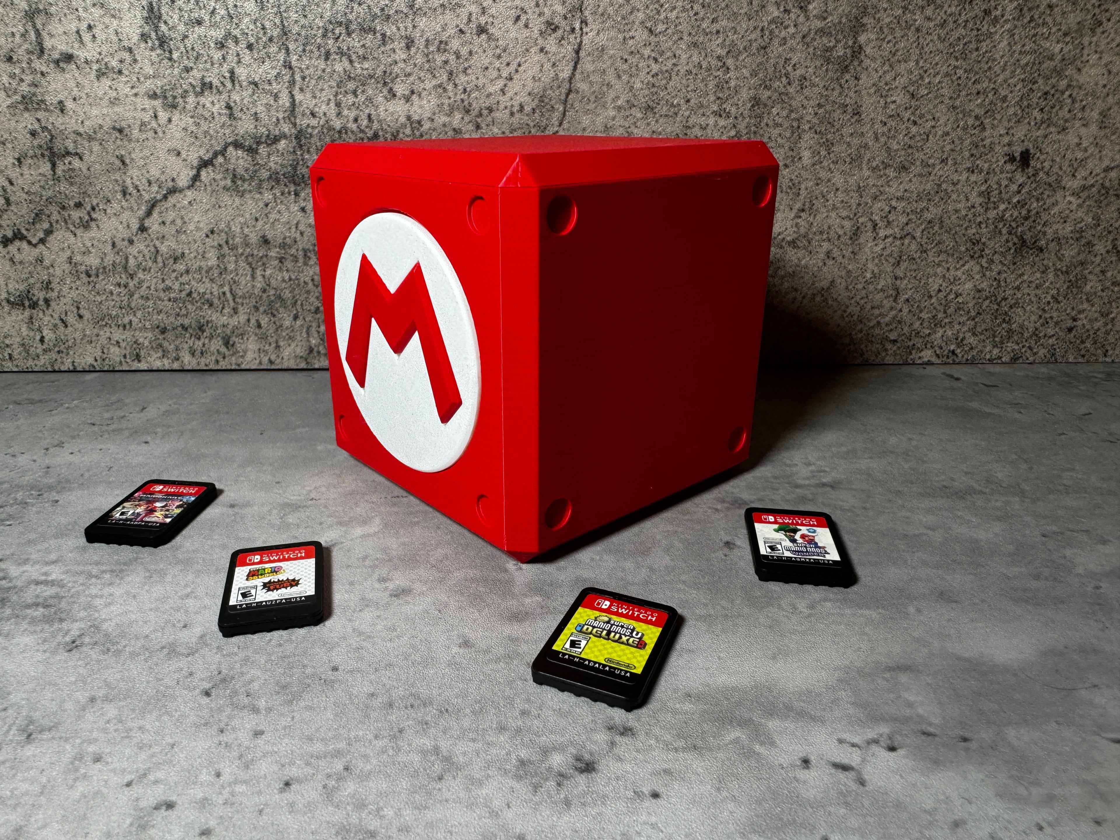 a red box sitting on top of a cement floor