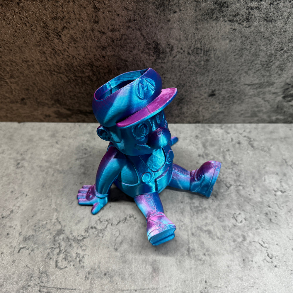 
                  
                    a blue and purple toy sitting on the ground
                  
                