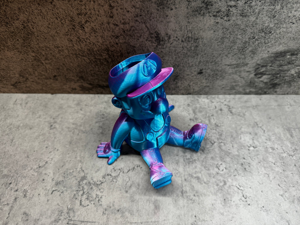 
                  
                    a blue and purple toy sitting on the ground
                  
                