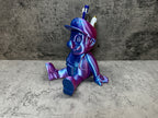 a purple and blue toy sitting on top of a table