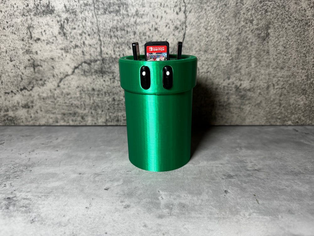 a green trash can sitting on top of a cement floor