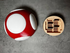 a red and white object sitting next to a white object