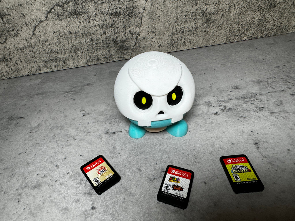 a white robot sitting next to a group of cell phones